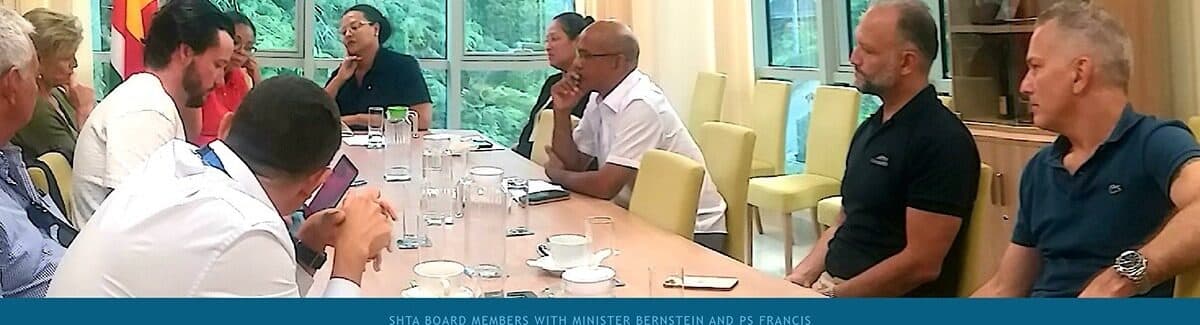 SHTA Board members and Department of Tourism officials seated around a long meeting table.