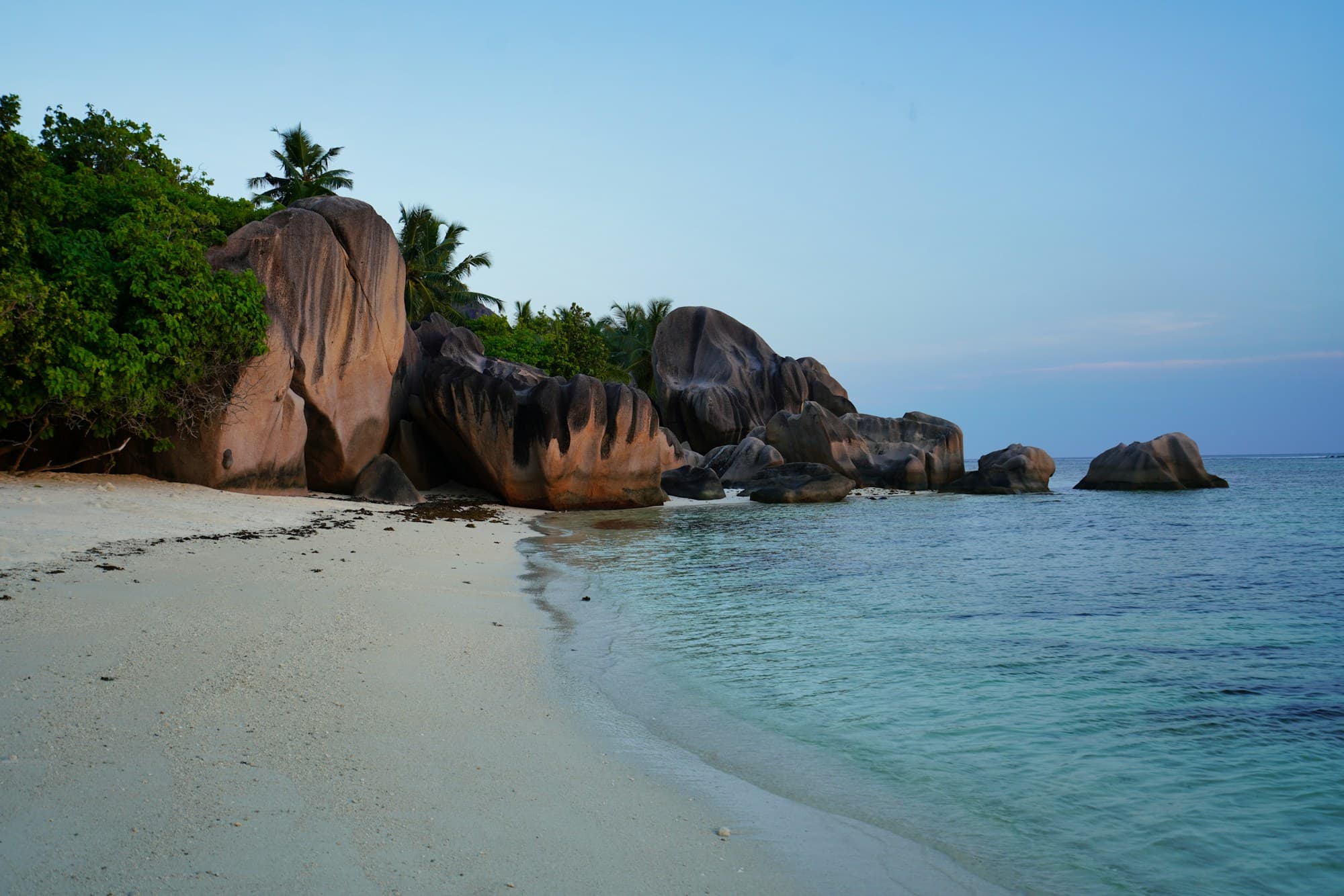 Granite boulders, coastal vegetation and the sea at Anse Source d’Argent, La Digue